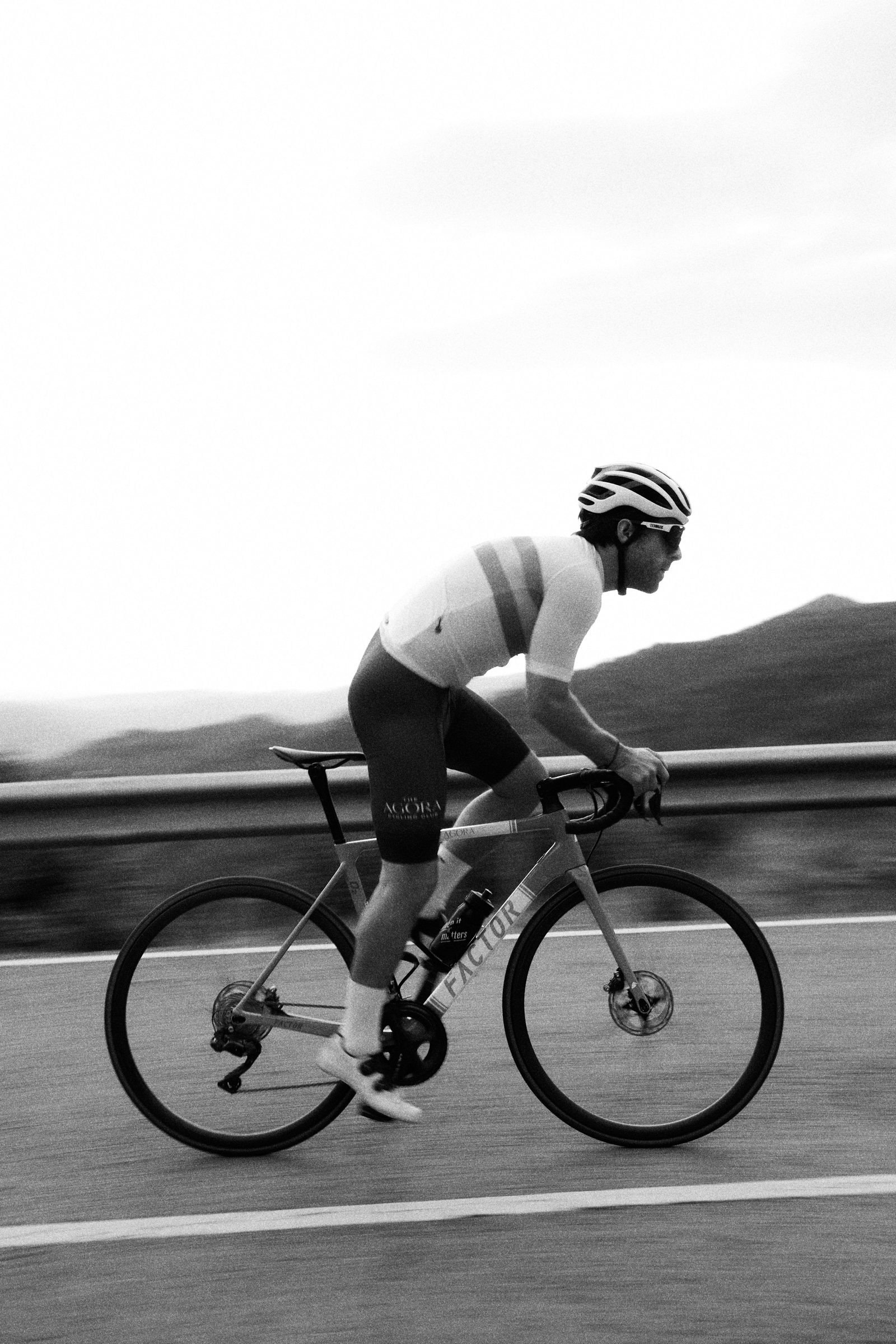 Cyclist carving through a mountain bend